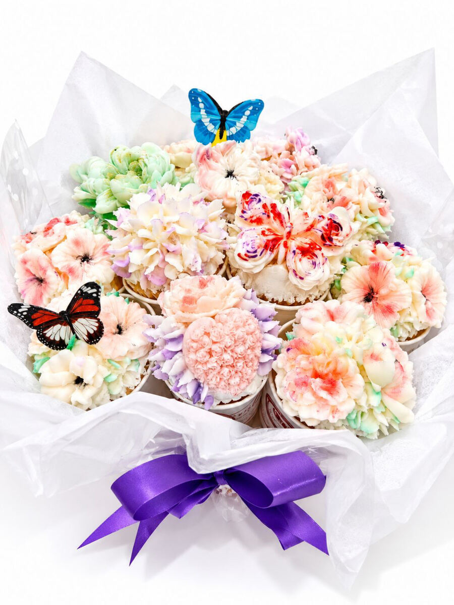 Pastel pink and peach buttercream cupcake bouquet with butterflies and purple ribbon, Gold Coast